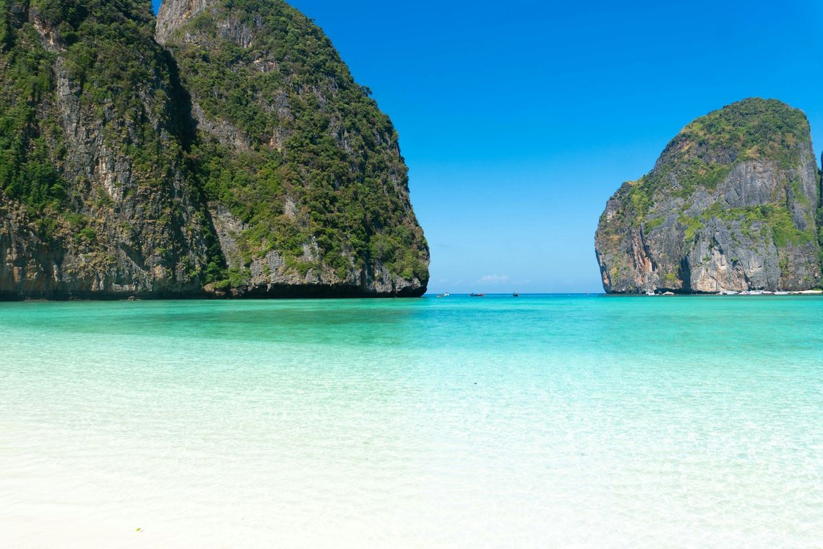 Strand med kalksteinsklipper og turkist vann pa Phi Phi
