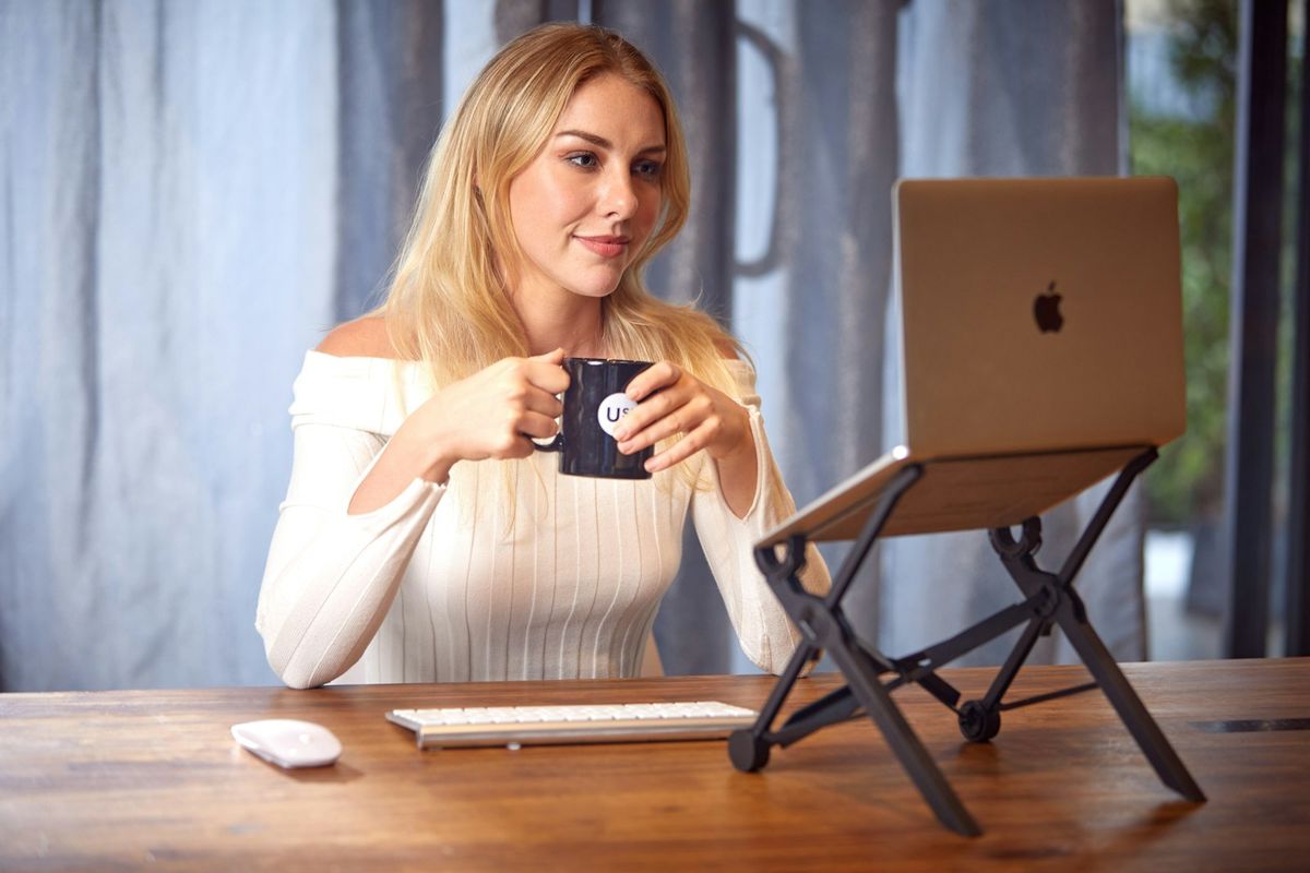 Kvinne med laptop og kaffe pa kafe